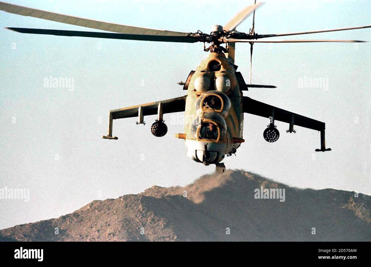 A Taliban militia helicopter flies over the north of Kabul October 27 as fighting on the front was heavy all day and still raging as darkness approached. Anti-Taliban forces struck at the purist Islamic militia from the air and on the ground expanding Afghanistan's latest war. Stock Photo