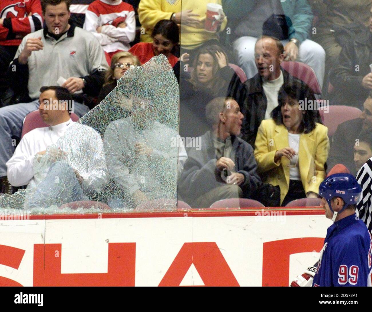 New Jersey Devils fans react a second after the glass shattered next to New  York Rangers center Wayne Gretzky (R) when it was hit by a puck in the  first period of