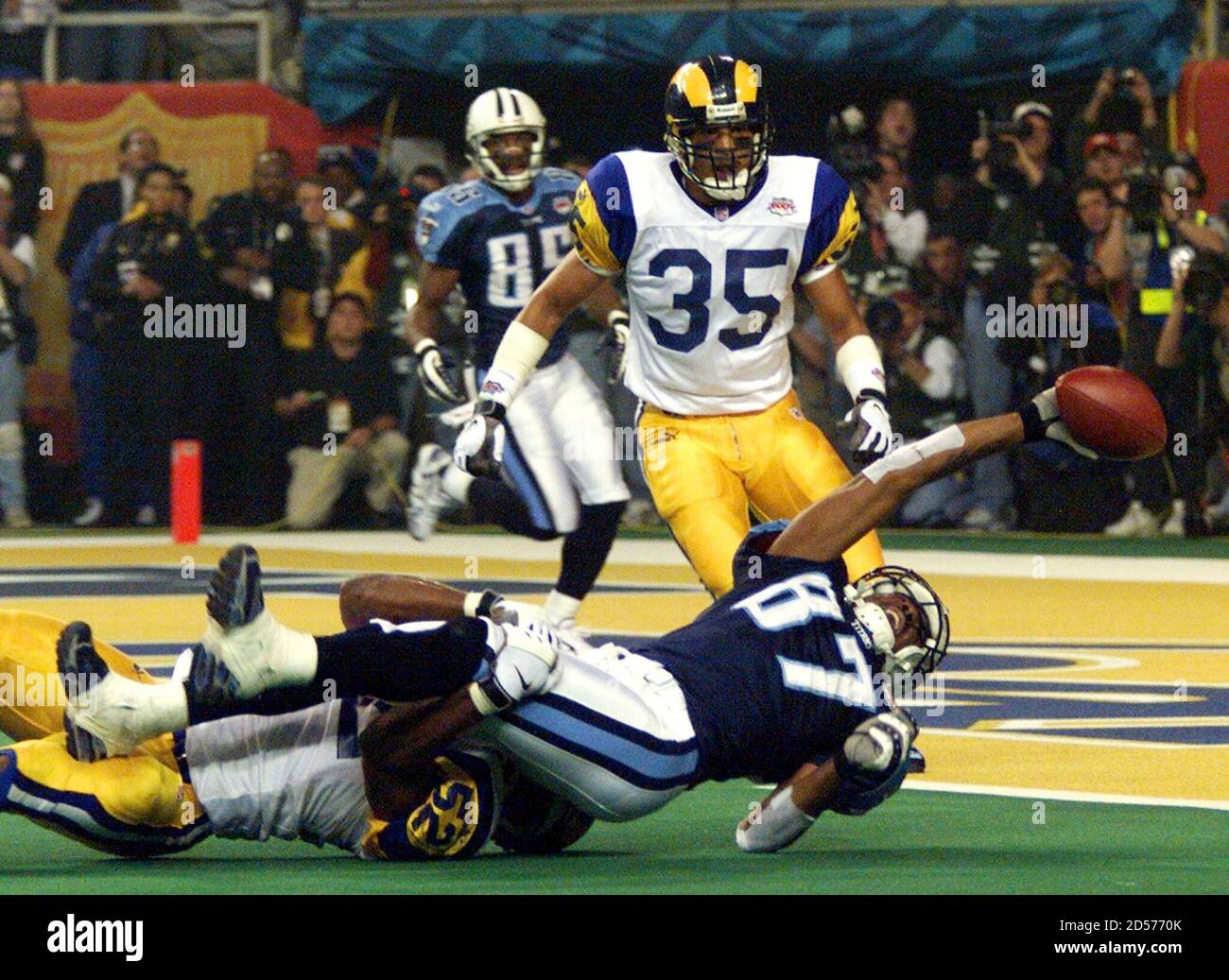 Tennessee Titans' wide receiver Kevin Dyson reaches out for the goal line  as he is tackled by St. Louis Rams' linebacker Mike Jones on the one-yard  line as Super Bowl XXXIV ends,