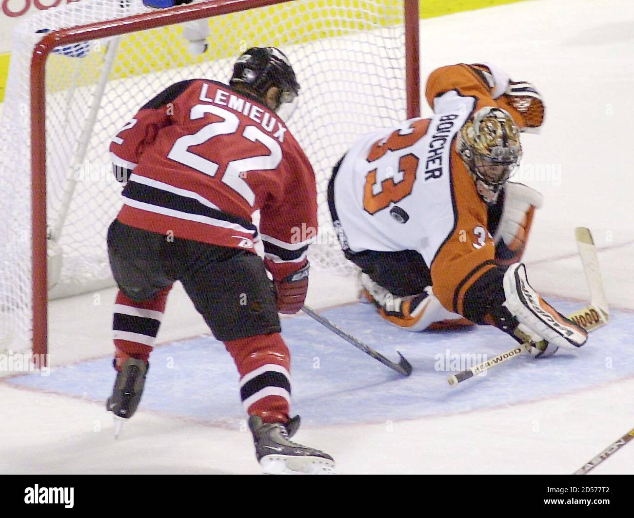 New Jersey Devils' Claude Lemieux (22) scores a fourth period goal against  Philadelphia Flyers goalie Brian Boucher (R) in Game 1 of Eastern  Conference final in Philadelphia, May 14. The Devils defeated