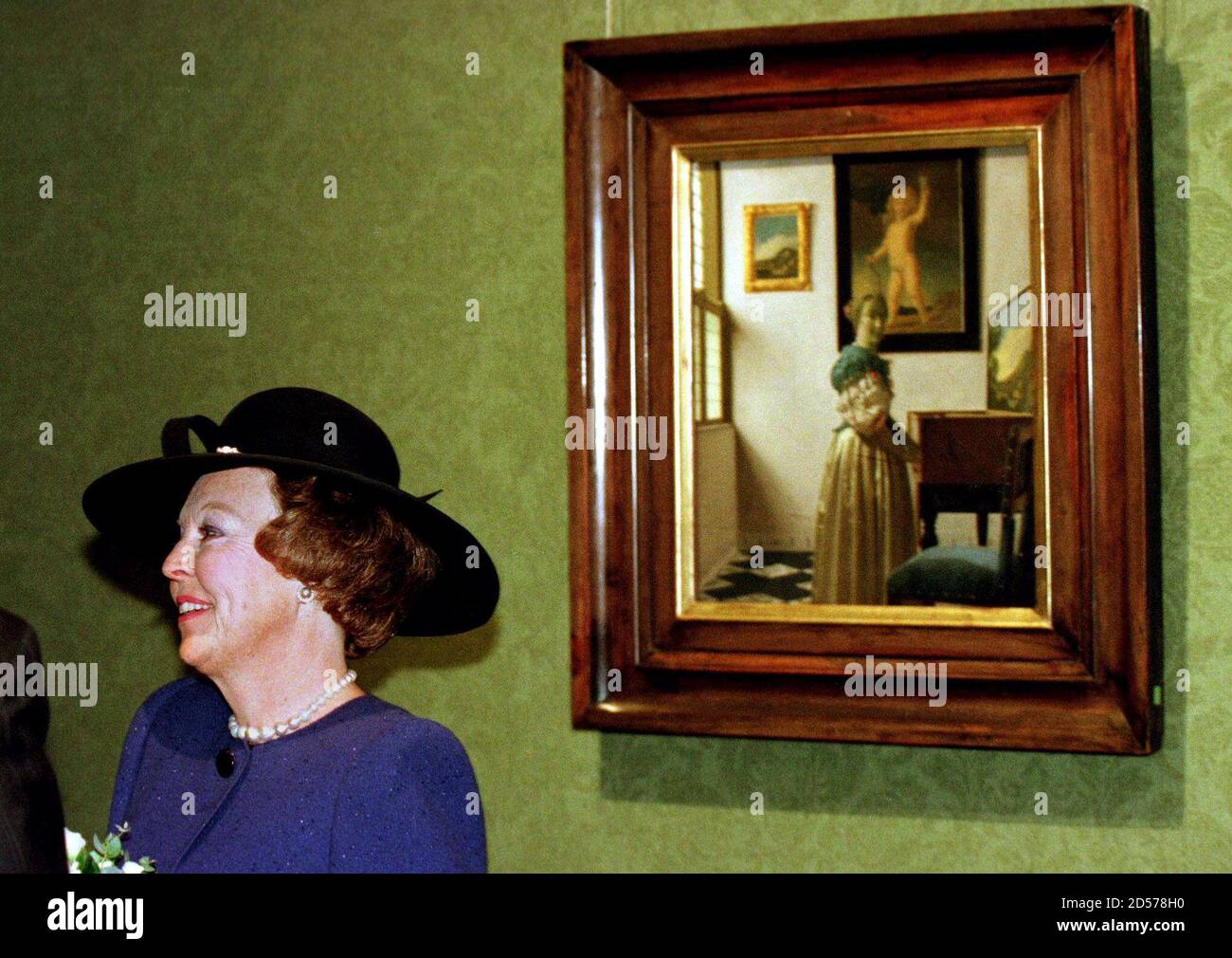 Dutch Queen Beatrix stands in front of 