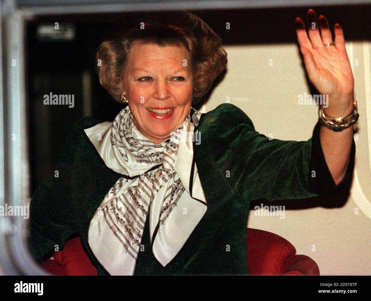 Dutch Queen Beatrix waves at the press from the royal train at Amsterdam  railway station before leaving for the city of Apeldoorn along with other  European Royal guests, January 31. Some 160