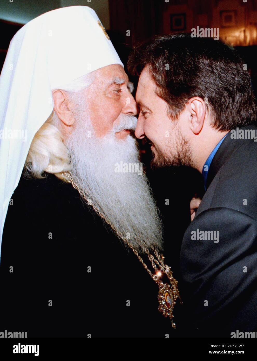 New Macedonian Prime Minister Ljupce Georgievski (R) receives blessing kiss from Macedonian Orthodox Archbishop Mihail (L) after inauguration ceremony in Skopje capita November 30. A new Macedonian government was voted into office by parliament on Monday, clearing the way for NATO to seek formal permission for an 'extraction force' to be deployed in the former Yugoslav republic. Last week top NATO officials said the force, meant to rescue unarmed international 'verifiers' from neighboring Kosovo in case of renewed fighting in the Yugoslav province, could be deployed as early as this week if it Stock Photo