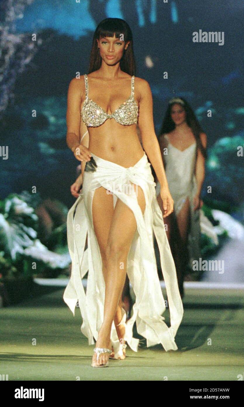 Model Tyra Banks wears a million dollar miracle bra with chiffon panel  skirt and white bikini at the end of the Victoria's Secret fashion show,  February 3 in New York City. The
