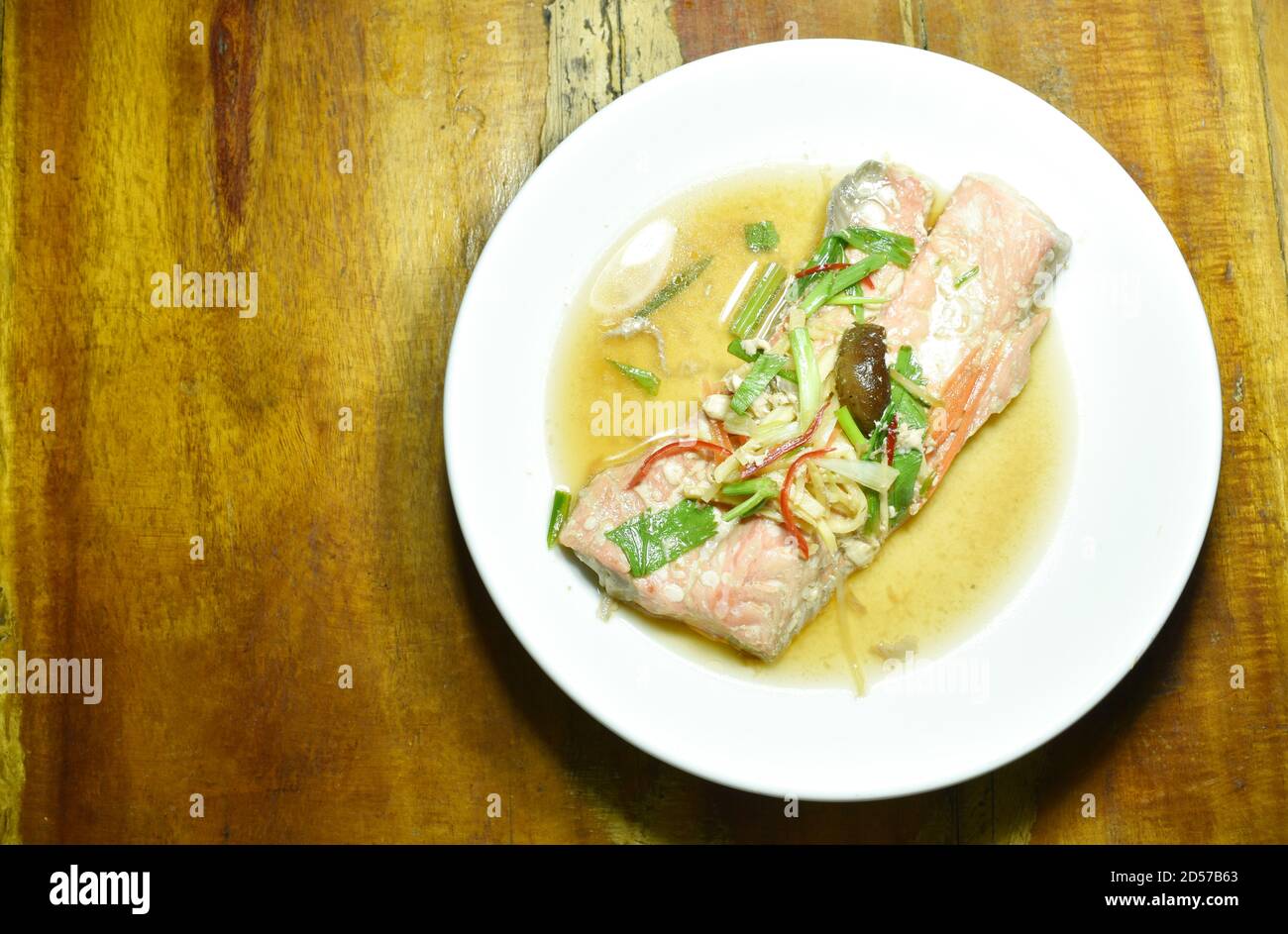 steamed salmon with soy sauce topping slice ginger on plate Stock Photo