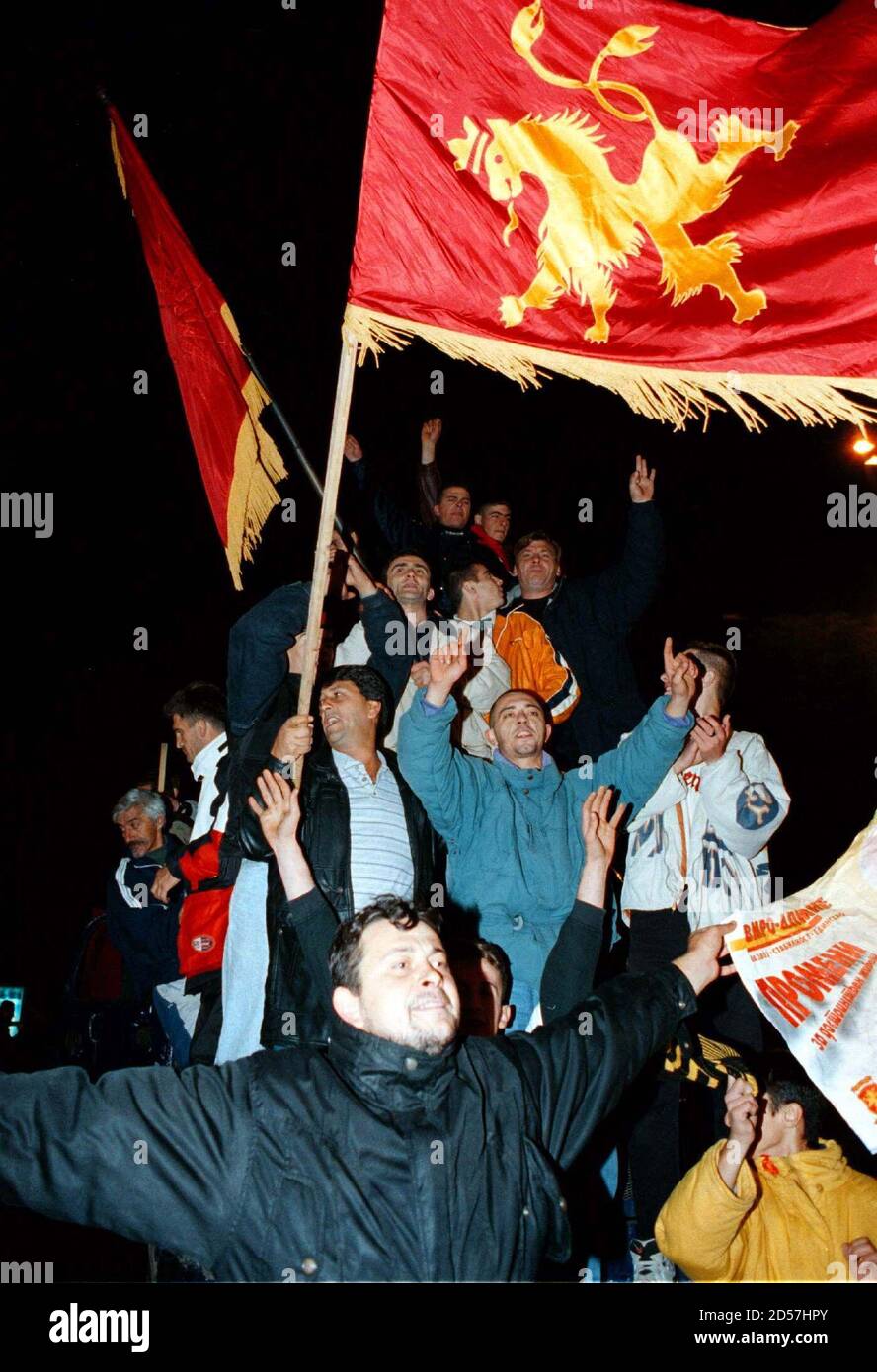 Supporters of Macedonia's main opposition Democratic Party for Macedonian National Unity (VMNO-DPNE) wave the party flag as they celebrate parliamentary election victory in Skopje early November 2. Macedonia's ruling socialists conceded defeat after the election, following decades of leftist government in the former Yugoslav republic. Ljubco Georgievski, president of the right-wing VMNO-DPNE party, said he and his pro-market partner the Democratic Alliance (DA) were on their way to form a government.  EV/WS Stock Photo