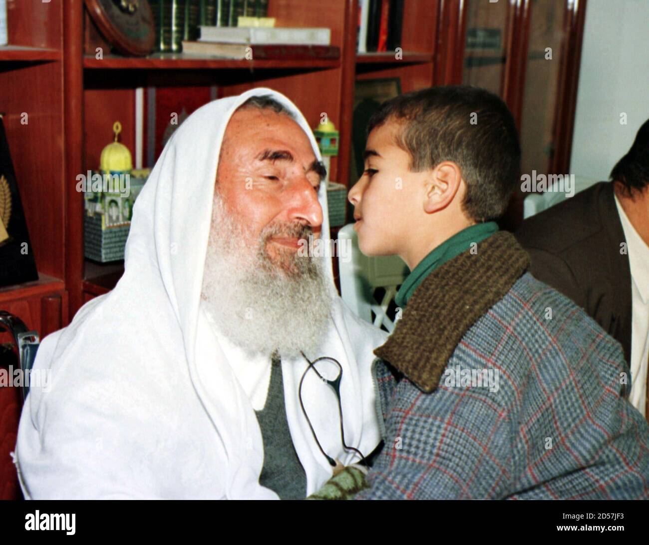 Sheikh Ahmed Yassin Founder And Spiritual Leader Of The Fundamentalist Hamas Movement Is Kissed By A Palestinian Child In His Home December 23 The Palestinian Authority Released Yassin Today From His House