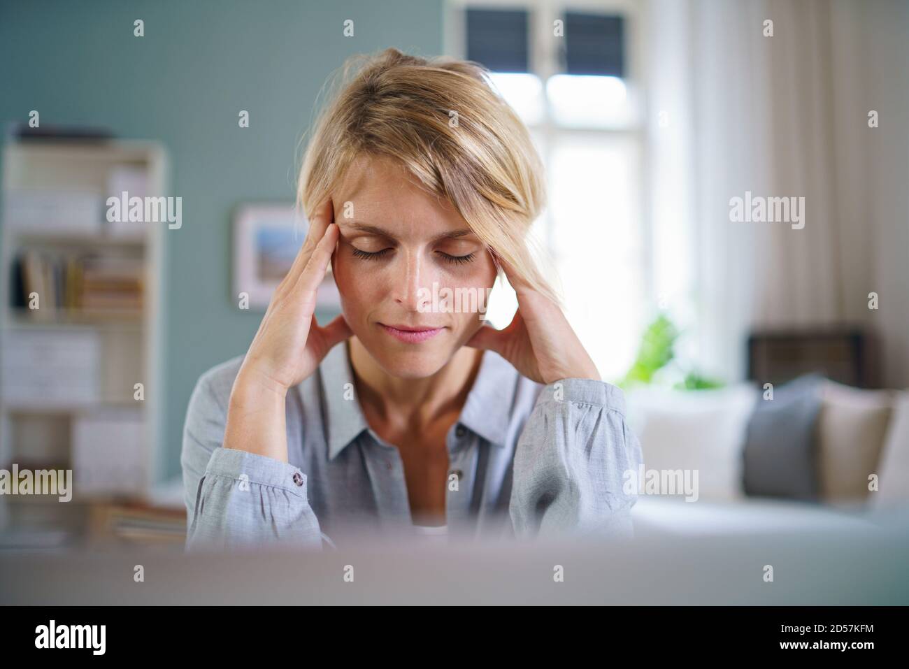 Portrait of business woman meditating indoors in office at desk, mental health concept. Stock Photo