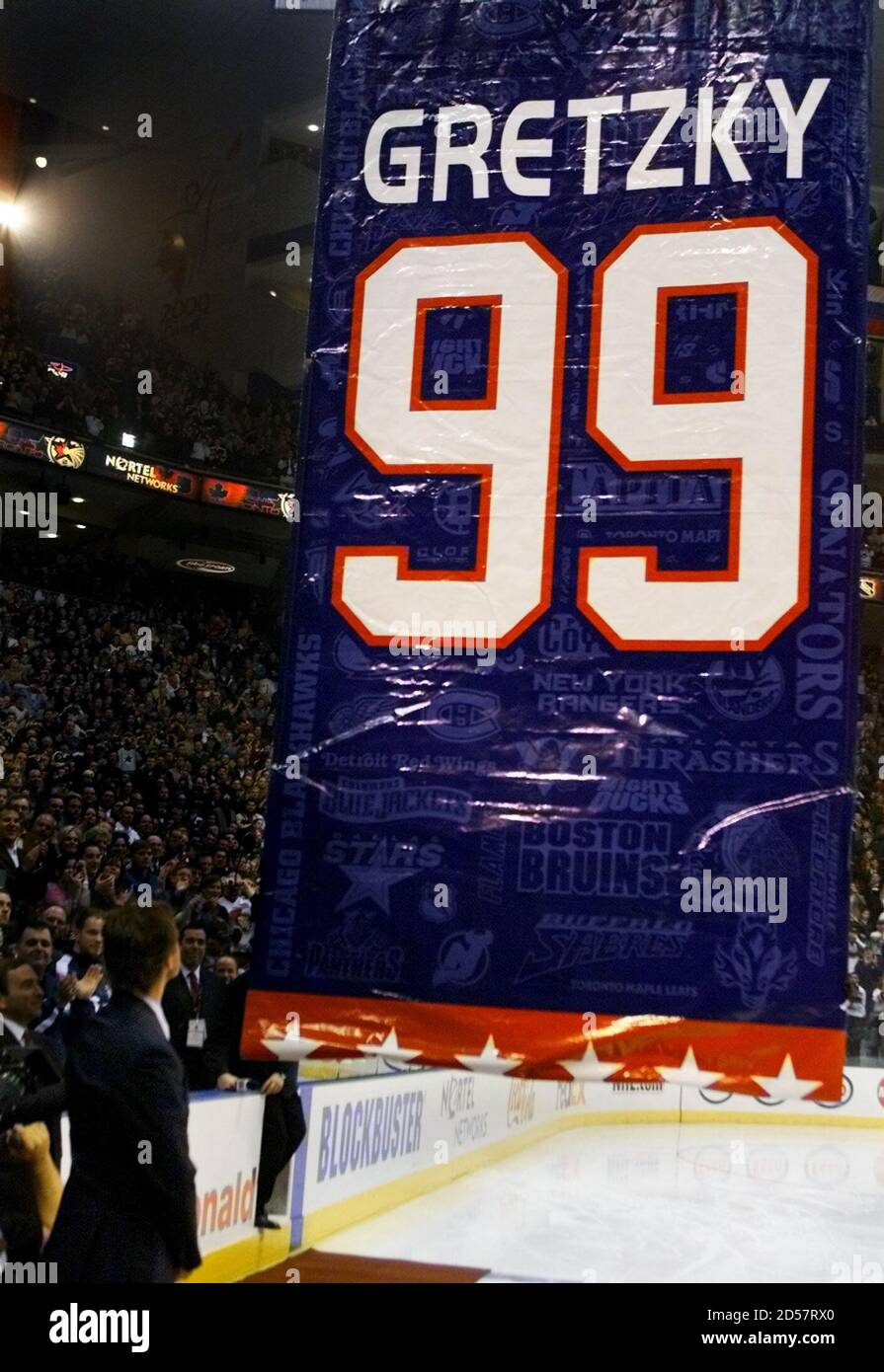 Retired hockey great Wayne Gretzky (L) watches a banner with his name and  number 99 being raised to the rafters in a ceremony retiring his number  prior to the 50th NHL All-Star
