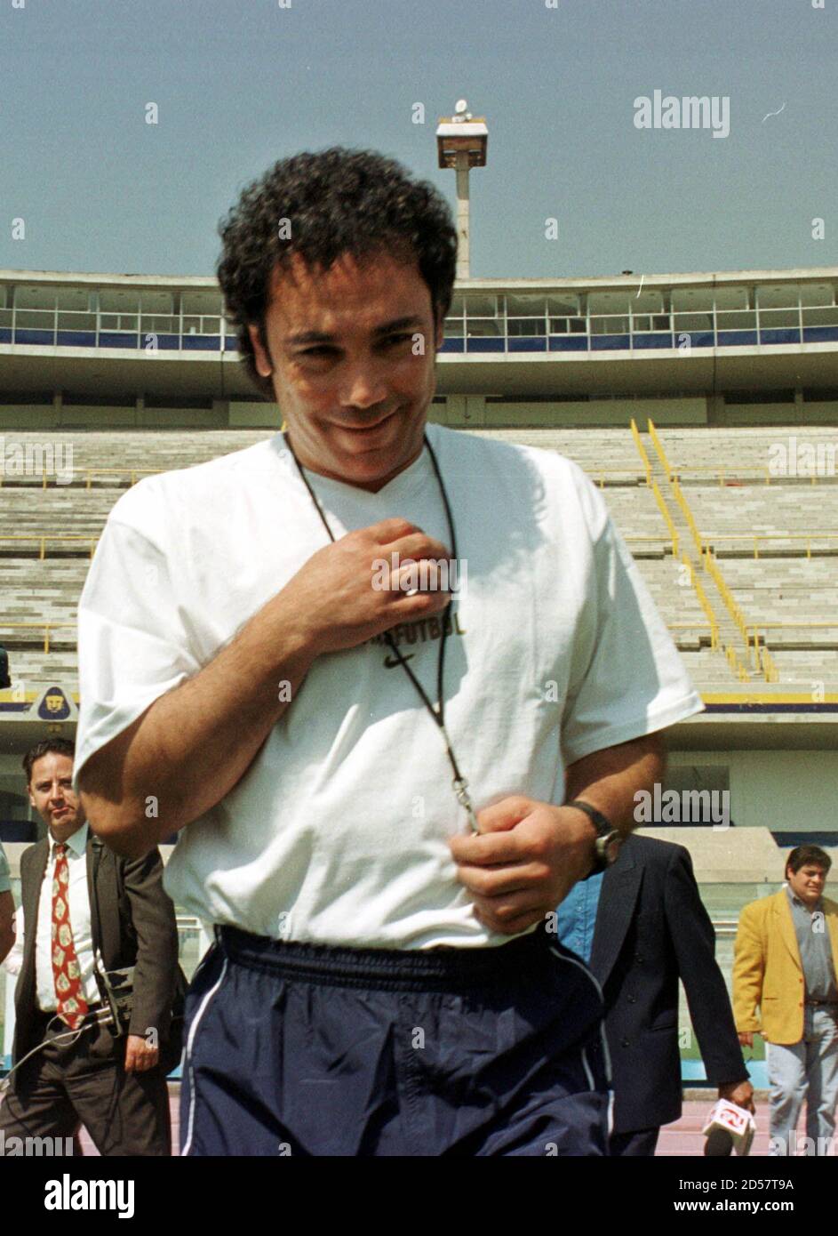 Former Mexican soccer star Hugo Sanchez persigns as he enters the pitch  during his presentation as the new coach of the soccer team Pumas, which  belongs to the National Autonomous University of