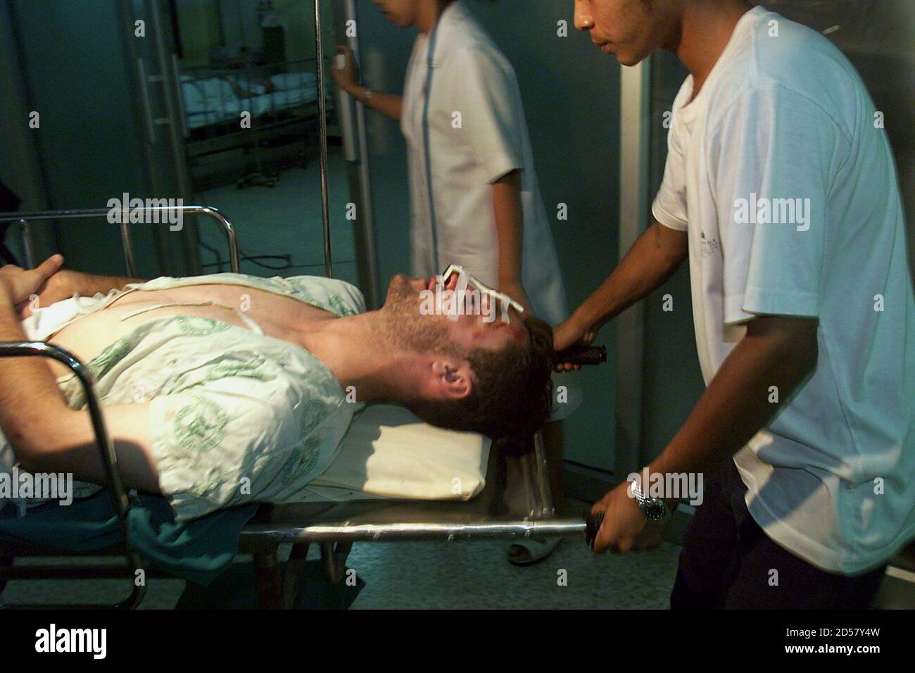 An unidentified German crash survivor is carried to the intensive care unit of a Surat Thani hospital December 12. The man is among 43 survivors of the Thai Airways Airbus A310 carrying 146 passengers that crashed in a flooded rubber plantation during an emergency landing in bad weather on Friday evening.    ??» Stock Photo