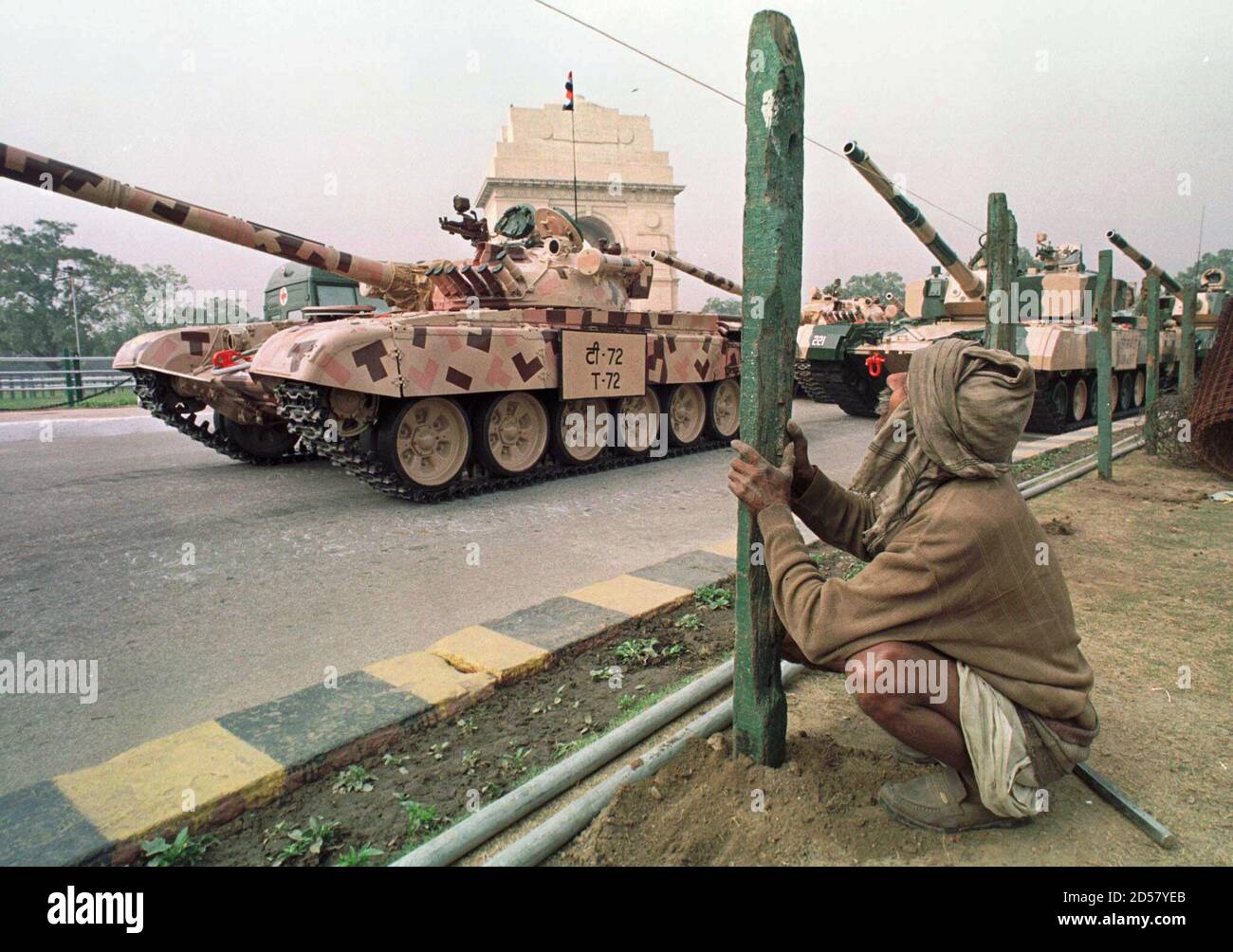 An Indian Labourer Assembles A Fence On January 17 In New Delhi As Indian Army T72 Battle Tanks Take Part In Rehearsals For The Annual Republic Day Parade The Russian Made T72 Tanks
