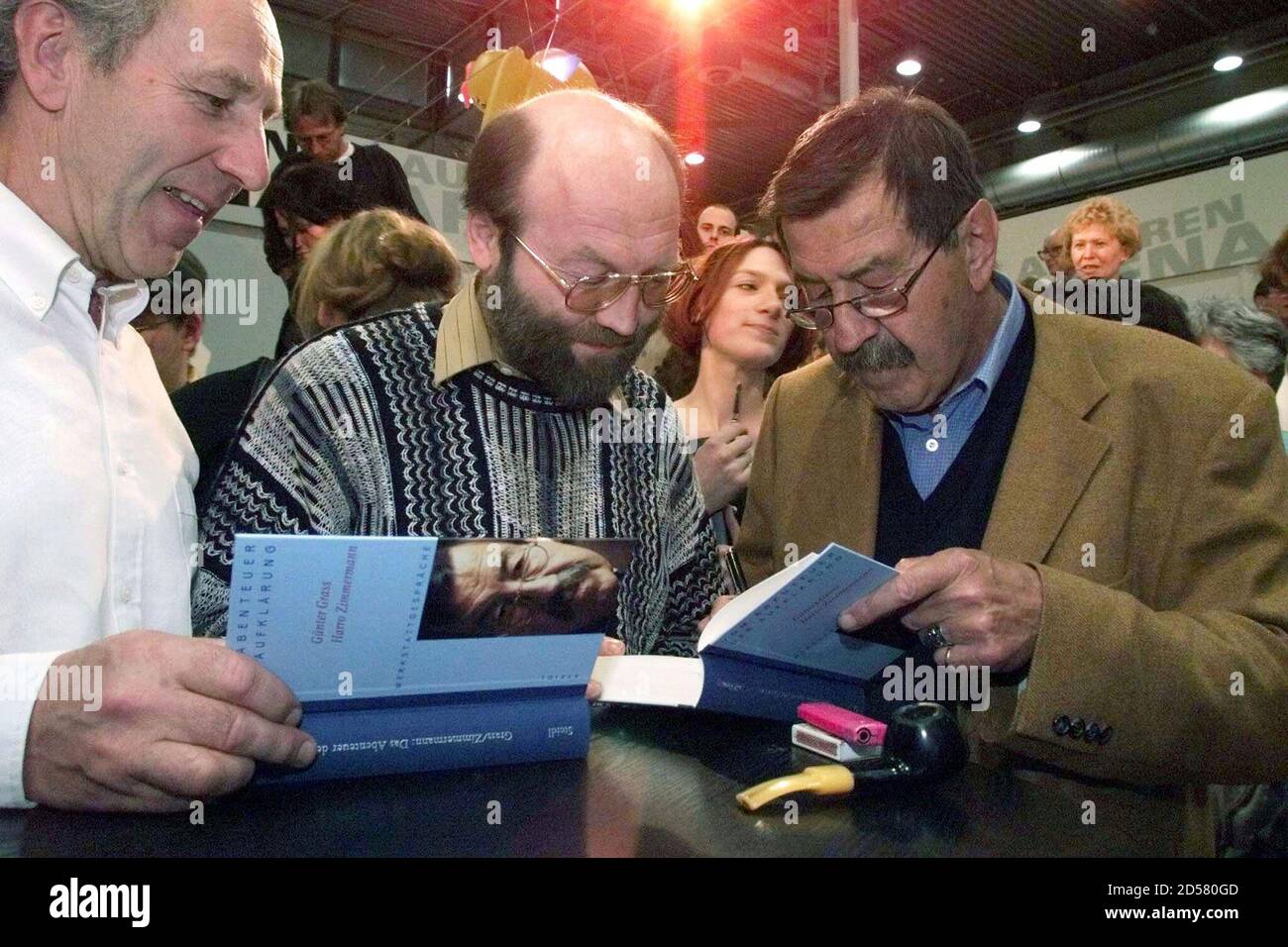 Famous German writer Guenter Grass (R) signs his new book 'Vom Abenteuer der Aufklaerung', which translates as 'About the Adventure of Enlightenment', at Leipzig's book fair March 27. The book fair takes place until March 28.  JE/JRE Stock Photo