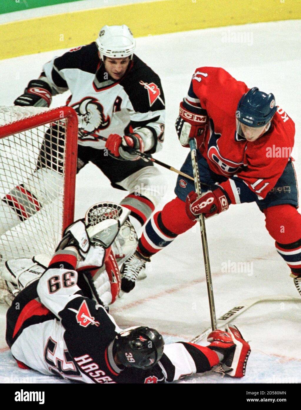 Montreal Canadiens Saku Koivu 11 Tries To Score On The Buffalo Sabres Goaltender Dominik Hasek 39 As Sabres Defenseman Darryl Shannon 8 Struggles To Hook Koivu During First Period Of Nhl Action