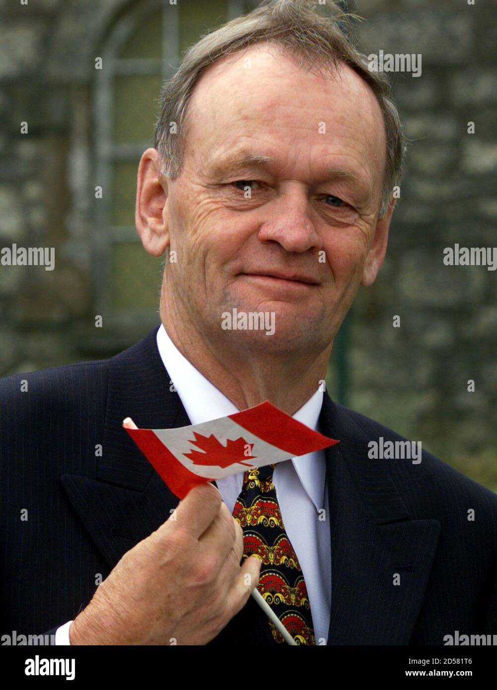 Canadian Prime Minister Jean Chretien waves a Canadian flag after  inaugurating the 'Canada Room' at the Glencree Centre for Reconciliation in  Co. Wicklow, June 14. Chretien met the Irish Prime Minister Bertie