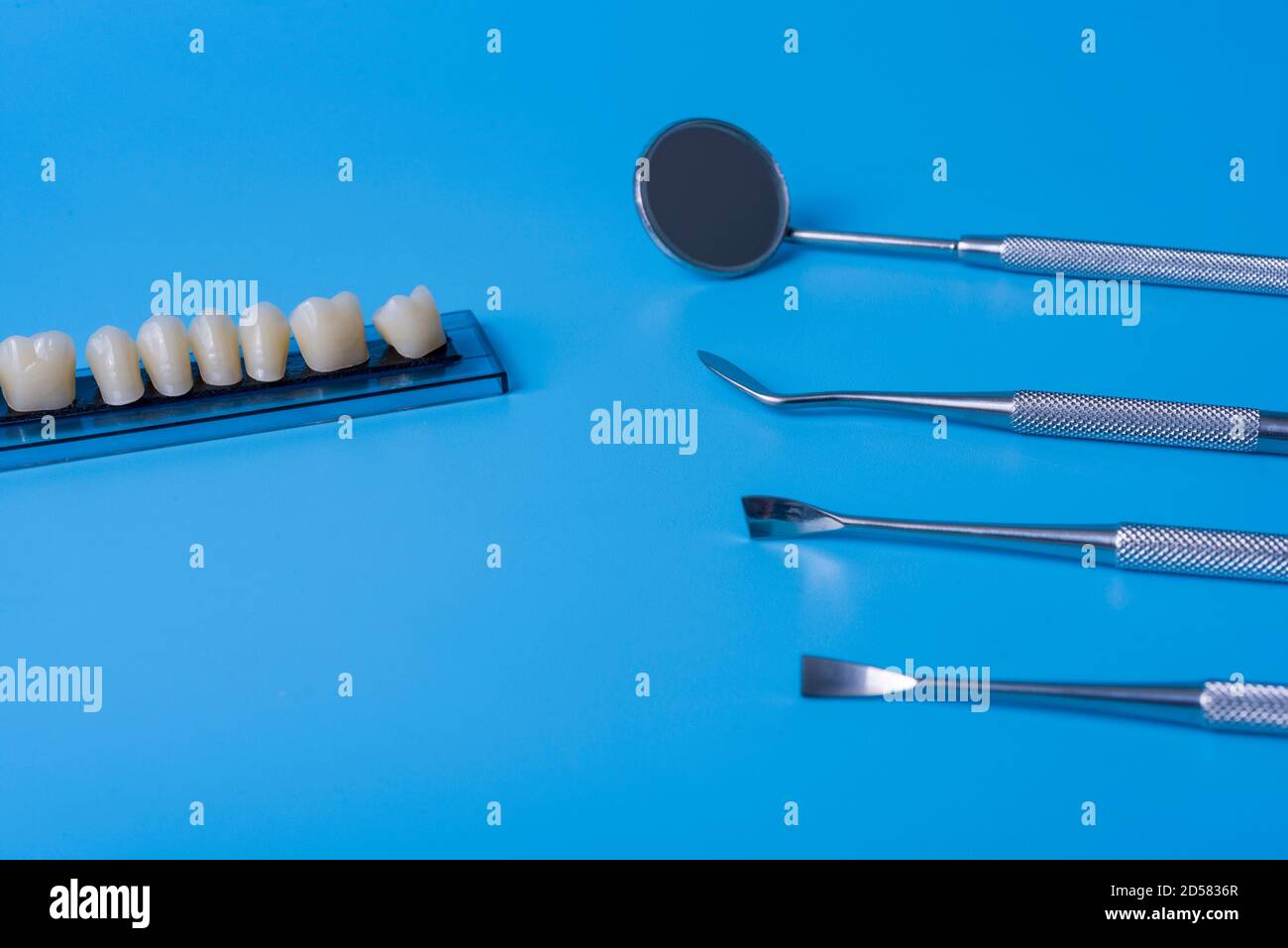Teeth model with dental tools on blue background. Concept of dentistry ...