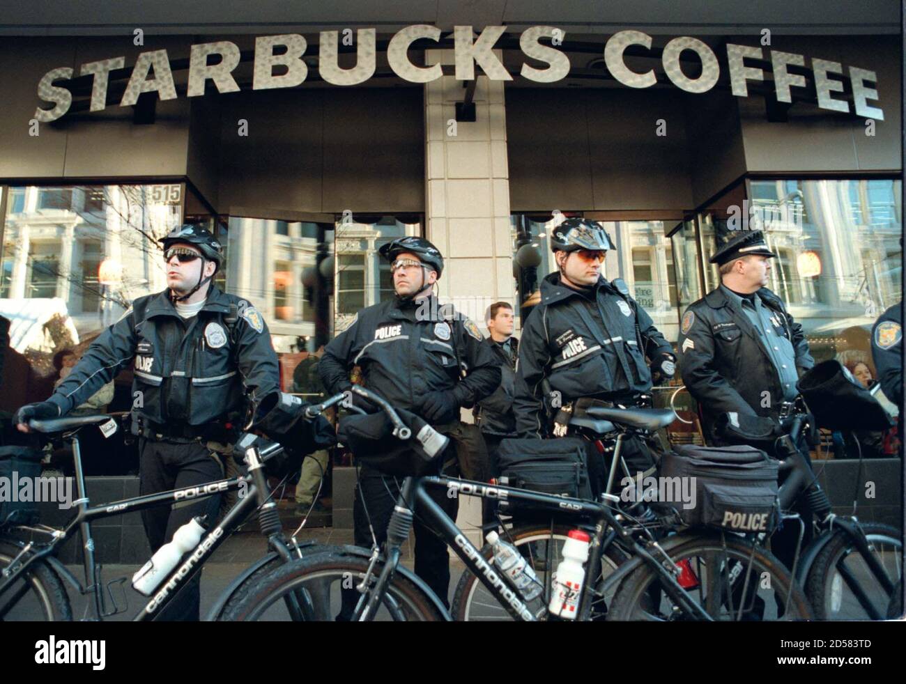 Seattle Police Officers Block The Entrance To A Starbucks Coffee Shop In Downtown Seattle After Several Hundred Protesters Gathered In Front To Protest Low Wages Paid To Workers November 28 One Day