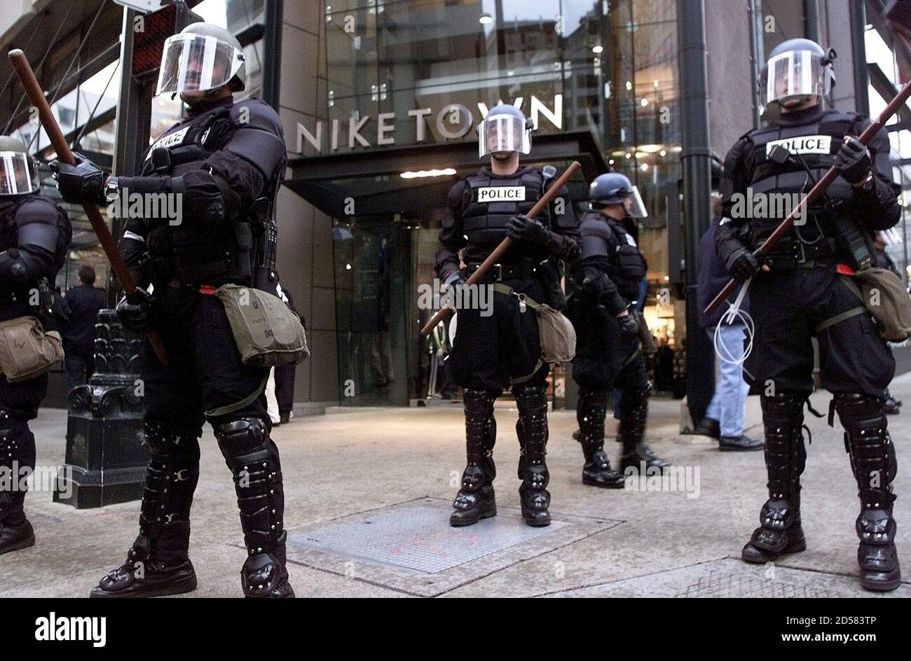 Seattle riot police guard the front of a Nike store in downtown Seattle  after several thousand protesters chanted on the street November 29.  Protesters who vowed to shut down global trade talks
