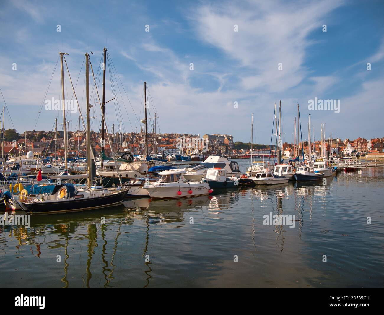 Leisure craft and small fishing boats moored at floating pontoons in Whitby Marina at the mouth of the River Esk - taken on a sunny day Stock Photo