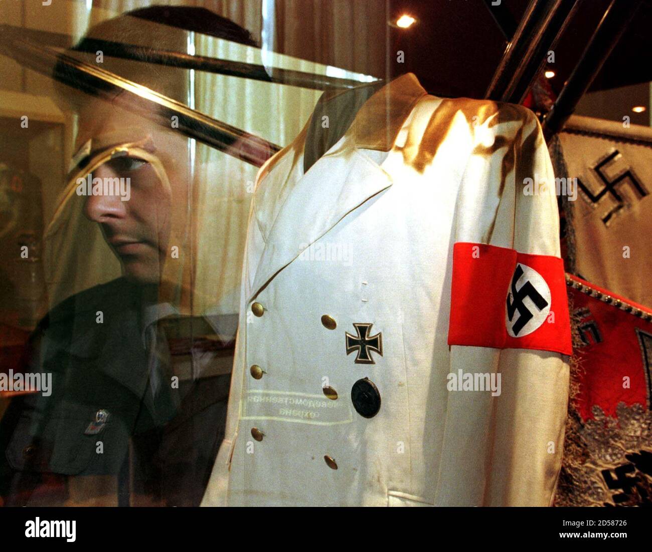 A visitor's face is reflected in a window as he looks at the suit of Nazi  dictator Adolf Hitler on special display at Russia's Defence Museum in St  Petersburg. The suit was