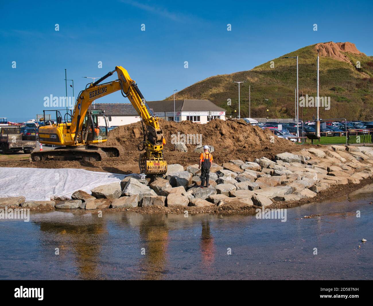 The construction of flood defences along Skelton Beck using heavy earth moving equipment and large stone blocks Stock Photo
