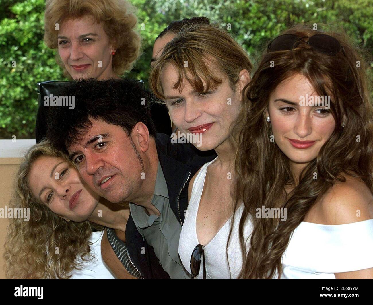 Spanish director Pedro Almodovar (2rd L) leans forward with actress Cecilia Roth (L) during a photocall with members of the cast, from L-R: Marisa Paredes, Candela Pena (hidden), Antonia San Juan, and Penelope Cruz May 15. Almodovar and his cast present their film 'Todo Sobre Mi Madre'  which will be screened in competition  at the 52nd Cannes Film Festival.         ??» Stock Photo