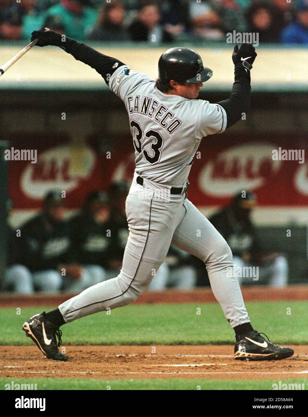 Tampa Bay Devil Rays' designated hitter Jose Canseco swings through on a  strikeout against Oakland Athletics' starting pitcher Kenny Rogers during  the first inning at the Oakland Coliseum, June 1. Canseco began