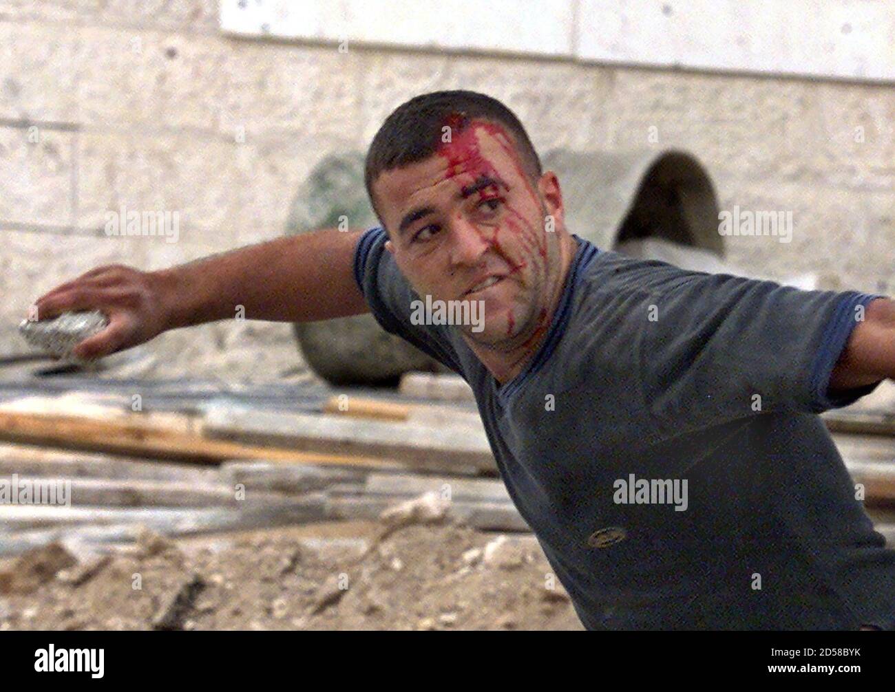 A Palestinian Demonstrator Bleeding From A Head Wound Hurls A Stone At Israeli Soldiers During Clashes Which Broke Out After A Palestinian Was Shot And Killed By An Israeli Soldier October 25