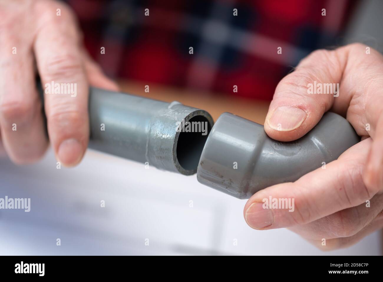 Plumber joining pvc pipe and fitting Stock Photo Alamy