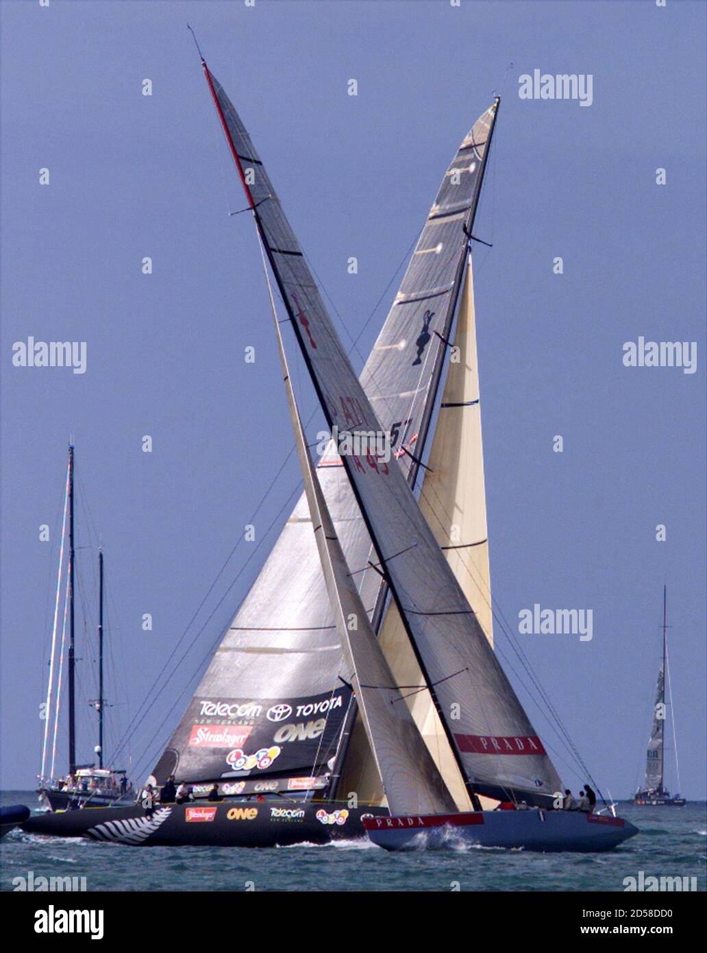 Team New Zealand (background) cross Italy's Prada while training for the America's  Cup out on the Hauraki Gulf February 10. Prada meet New Zealand, the holder  of the America's Cup in the