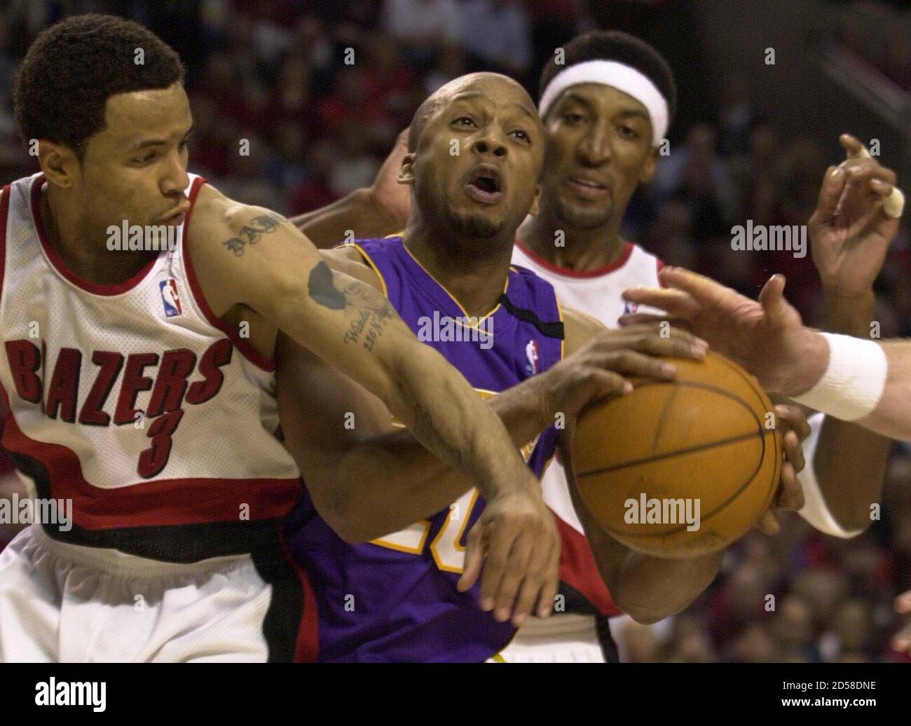 Damon Stoudamire L And Scottie Pippen R Of The Portland Trail Blazers Go After Loose Ball With Los Angeles Laker Brian Shaw C During The Fourth Quarter Of Their Nba Game In