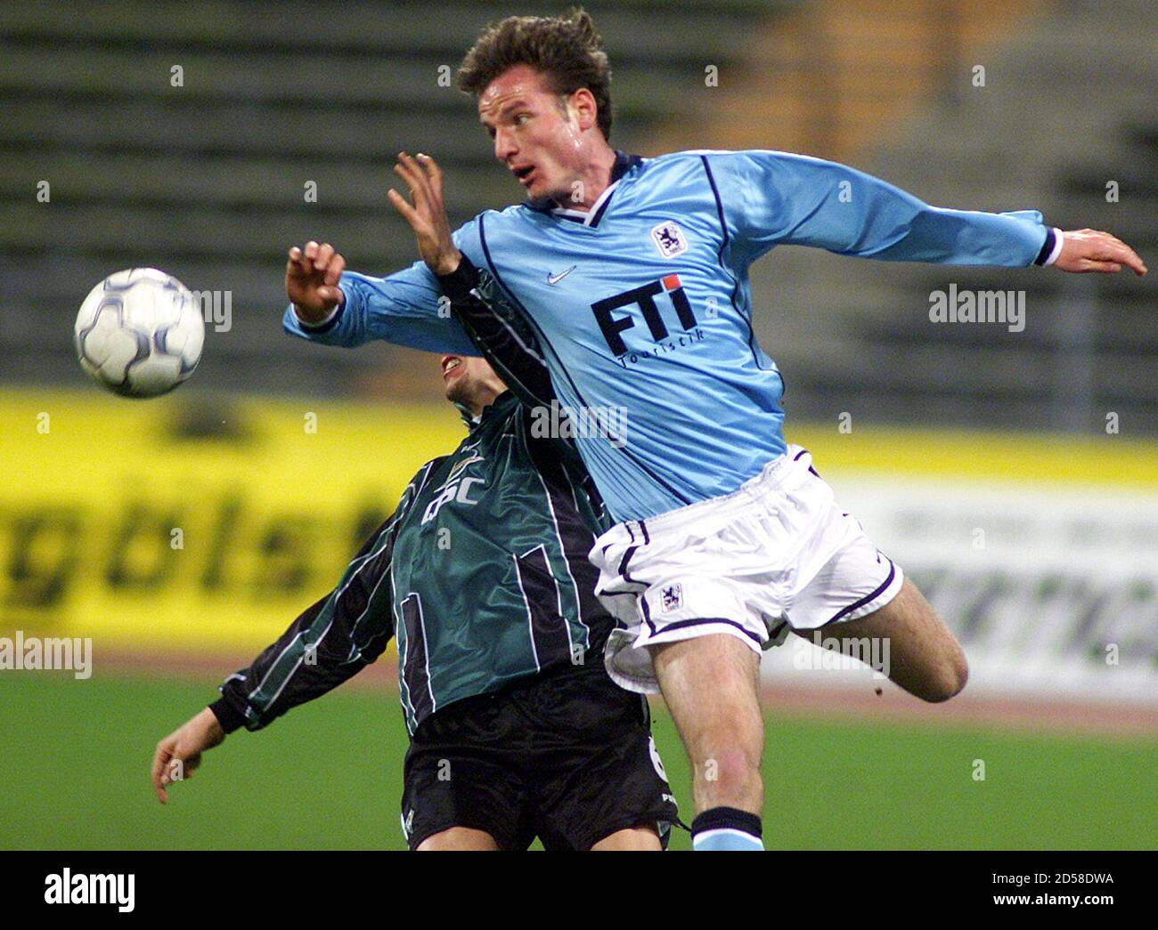 CERNY FROM TSV 1860 MUNICH CHALLENGES BAUMANN FROM WERDER BREMEN DURING FIRST DIVISION SOCCER MATCH IN MUNICH.   Harald Cerny (R) from TSV 1860 Munich challenges Frank Baumann from Werder Bremen during their German first division soccer match in Munich's olympic stadium, March 19. Munich won the match 1-0. Stock Photo