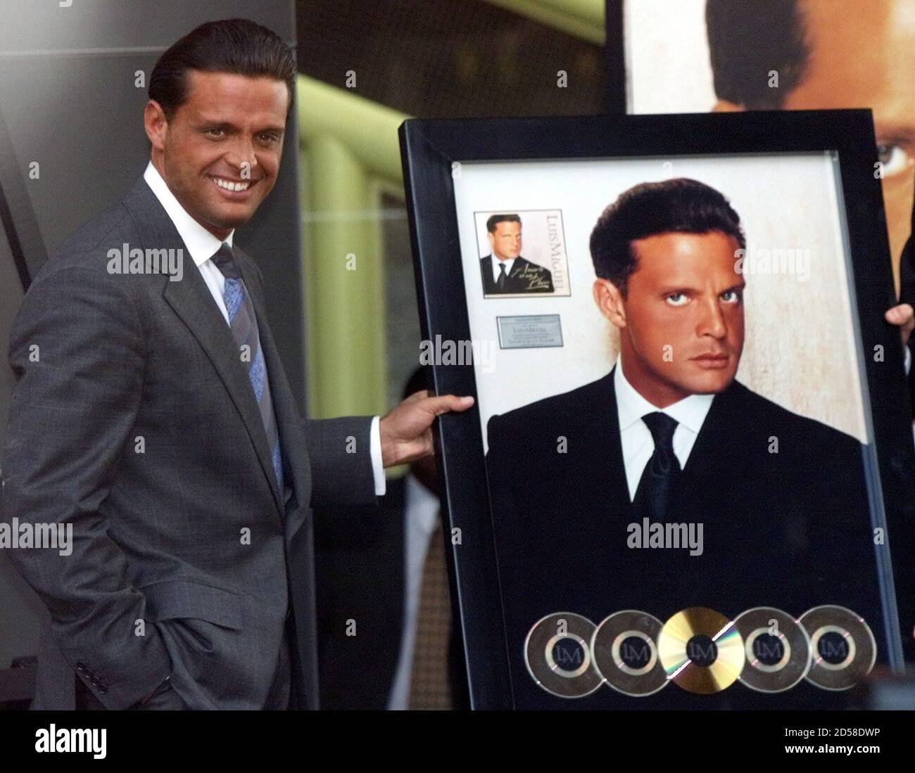 Mexican pop star Luis Miguel shows off his four-platinum award and  one-golden award March 20 during a ceremony in Mexico City's National  Auditorium. Luis Miguel has performed his songs before over a