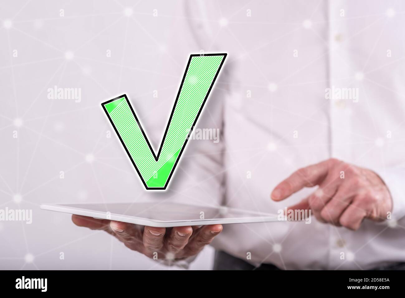 Validation concept above a tablet held by a man in background Stock Photo