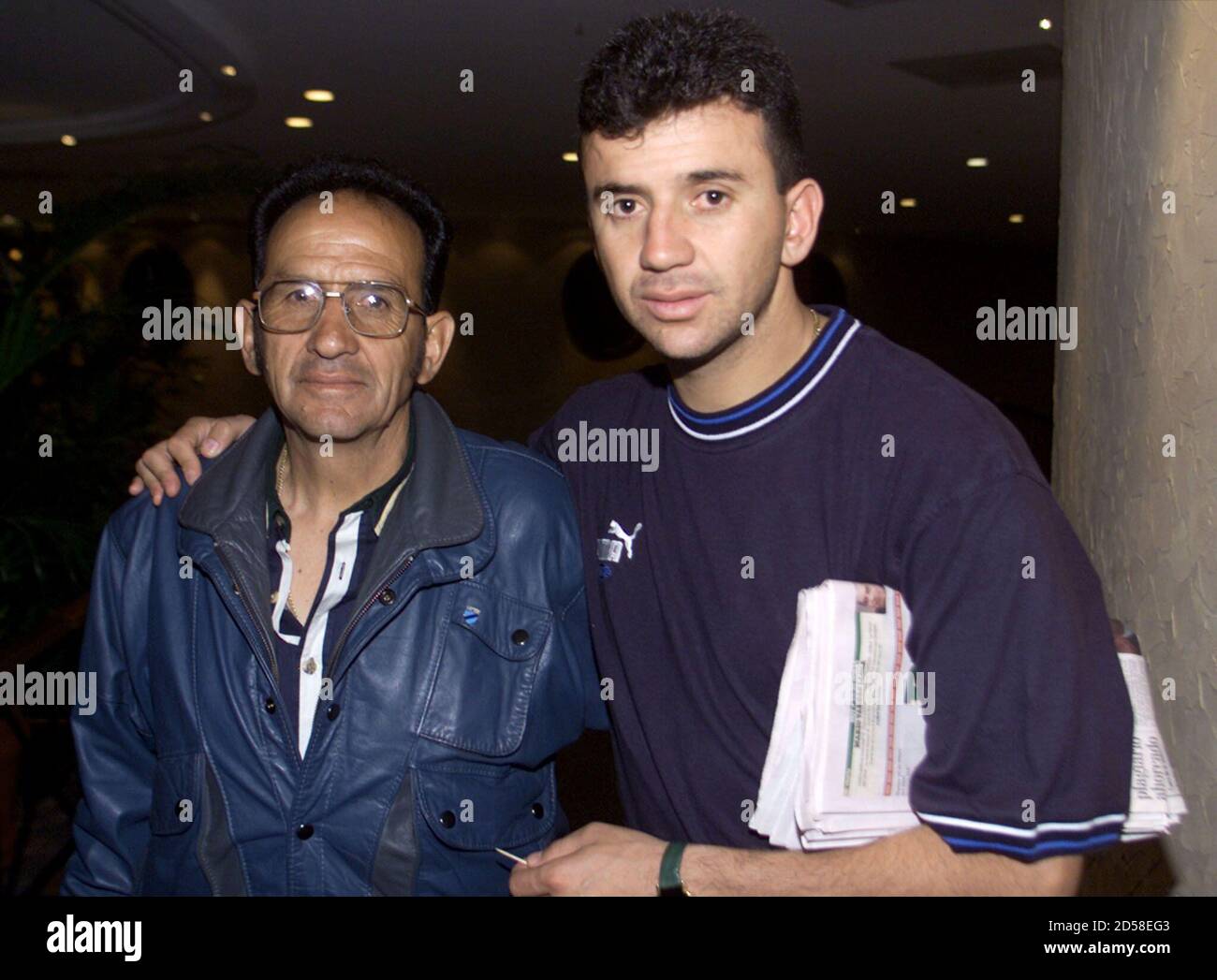 Bolivian player Julio Cesar Valdivieso (R) of club Bolivar de la Paz and  his father Enrique Valdivieso Hernadez pose as they arrive at the Hotel  Melia in Mexico City, May 16. Bolivar