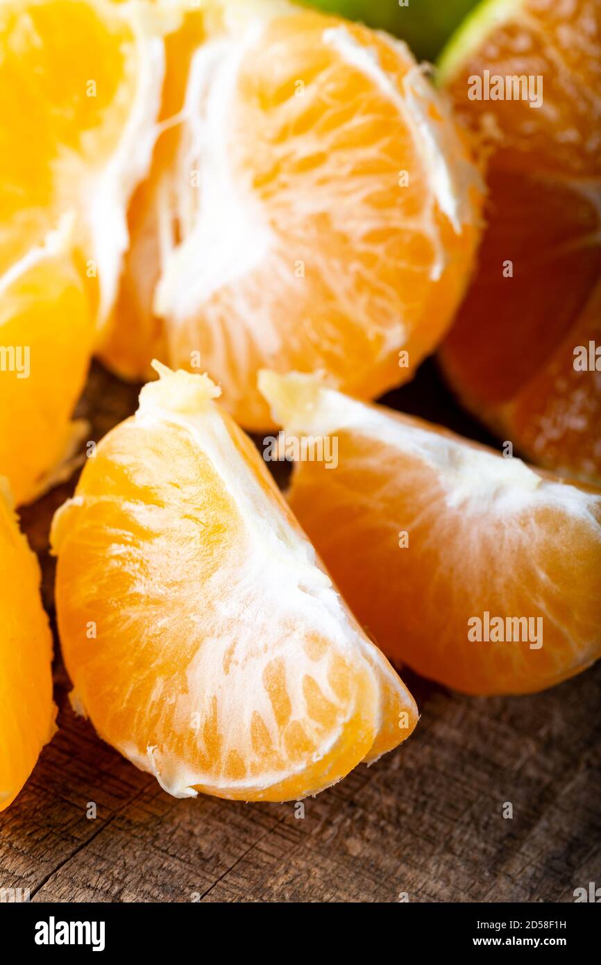 Slices of mandarine on wooden board. Stock Photo
