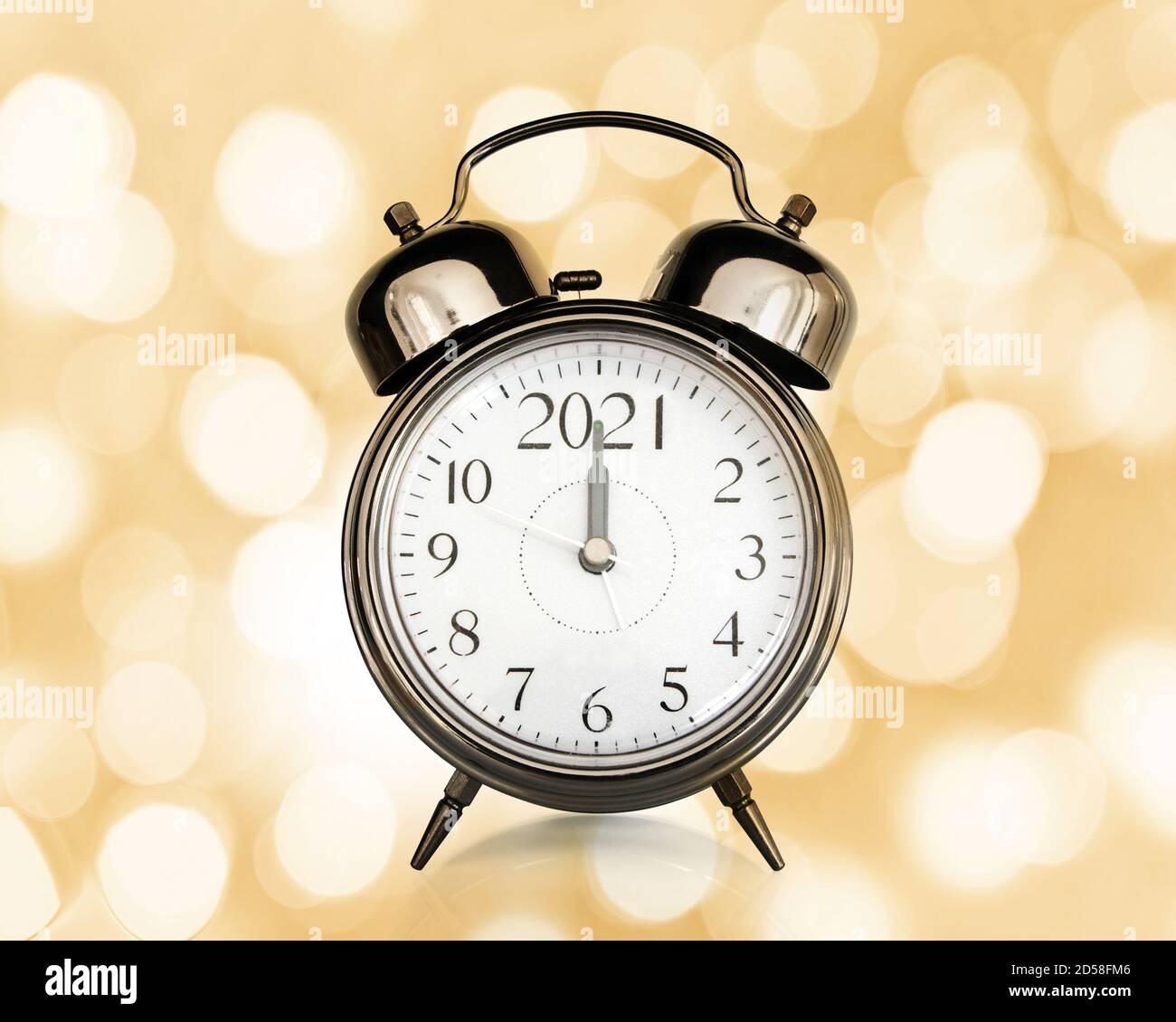 2021 written on a vintage alarm clock, bokeh lights background, happy new year eve party time and midnight countdown celebration concept Stock Photo