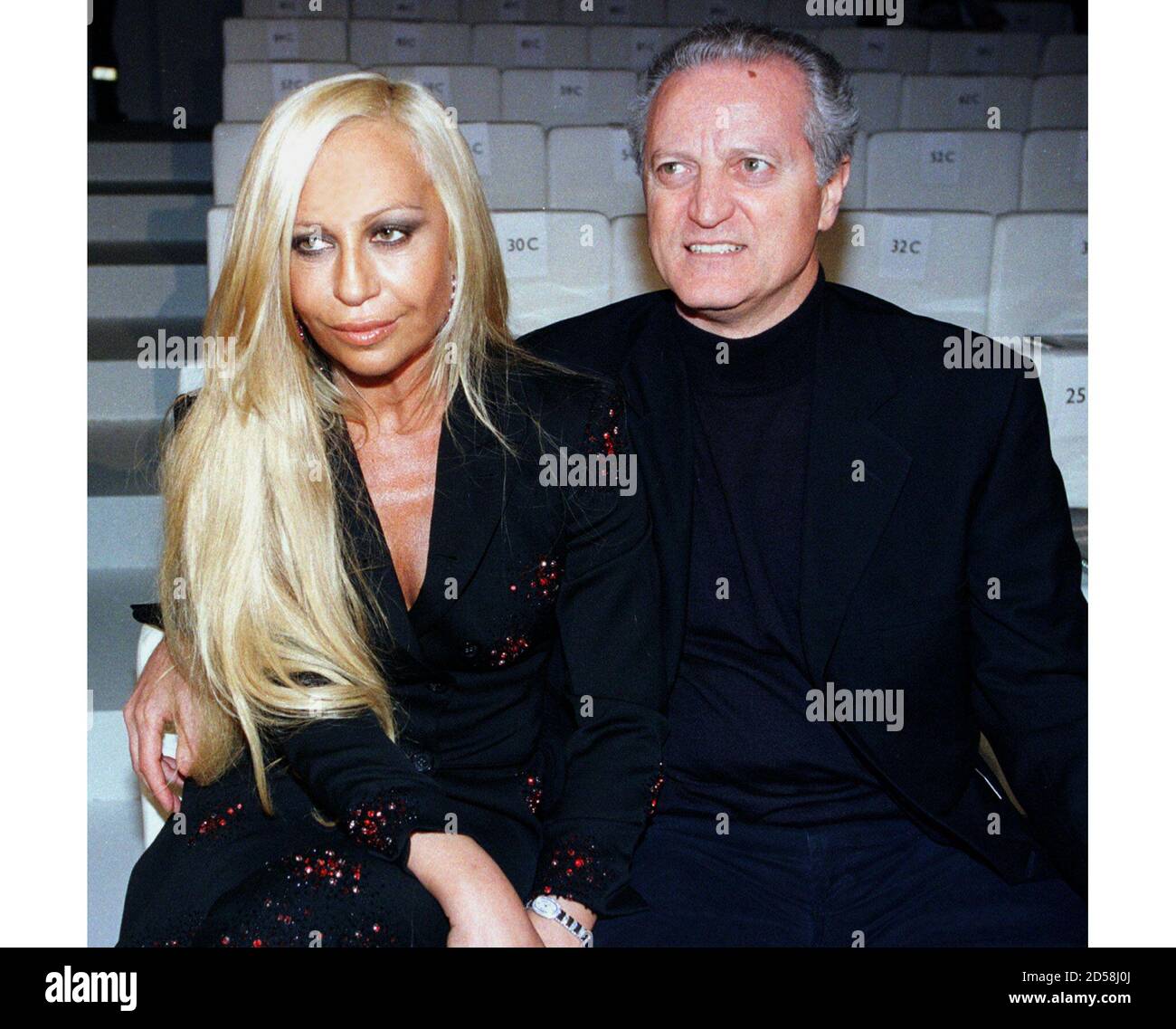 Italian designer Donatella Versace and her brother Santo sit together  before the Gucci autumn/winter 1999-2000 collection at a Milan fashion show  March 2. Milan's fashion shows will end on March 5 with