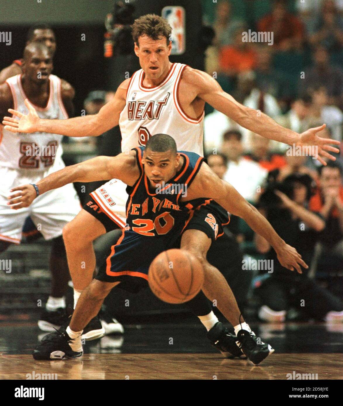 New York Knicks' guard Allan Houston (front) eyes a loose ball as Miami Heat  guard Dan Majerle defends during the second period of NBA playoff action  May 8. Houston scored 22 points