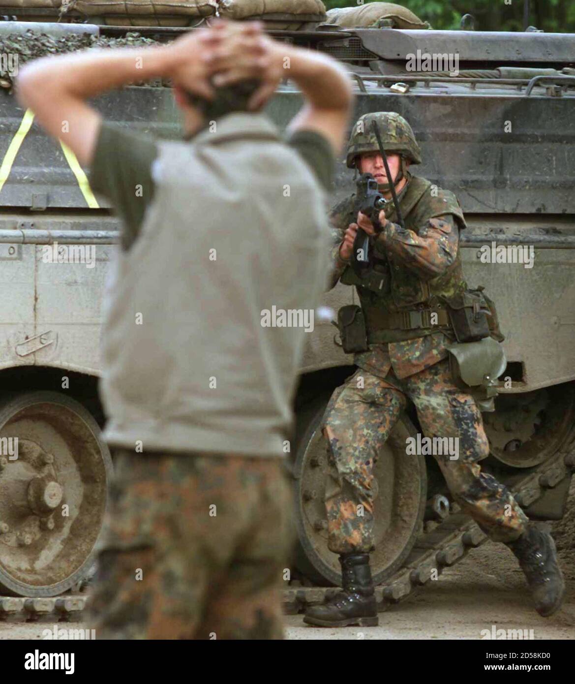 One Of A Squad Of German Soldiers Makes An Arrest Of A Man Playing The Part Of A Suspected Guerrilla Fighter During A Press Presentation At Their Military Training Area In Munster
