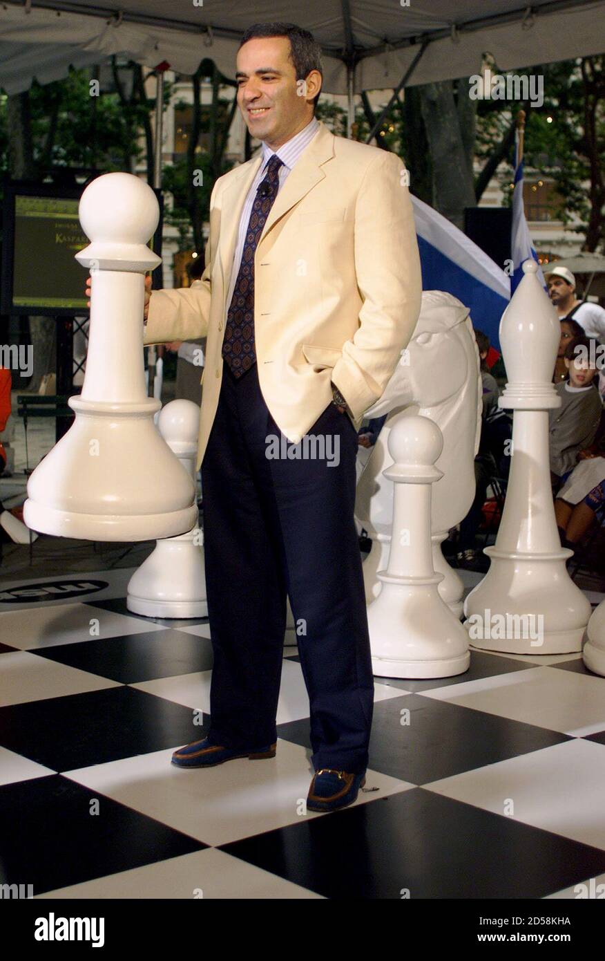World Chess Champion Gary Kasparov makes his first move on a large chess  board in New York's Bryant Park June 21 during an Internet chess game where  he will take on players