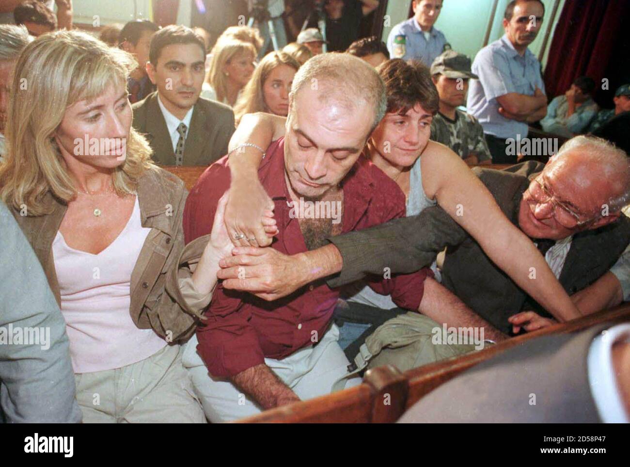 Cristina Cabezas L Widow Of Argentine Photojournalist Jose Luis Cabezas Murdered In 1997 Holds Hands With Sister In Law Gladys 2ndr Father In Law Jose R And An Unidentified Relative 2ndl During The Reading Of The