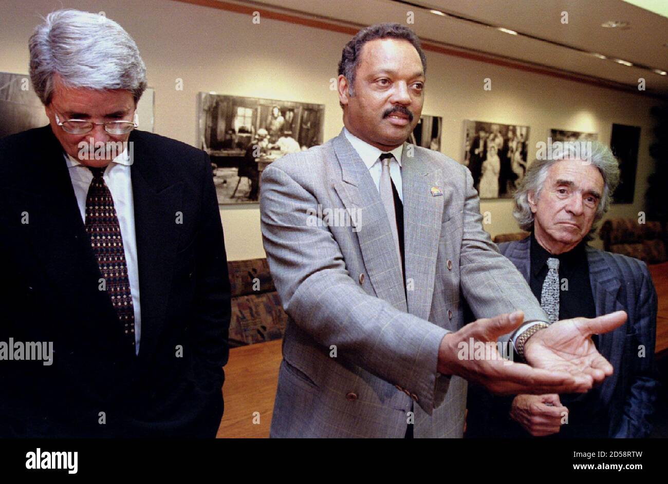 Rev. Jesse Jackson (C) and Academy of Motion Pictures, Arts and Sciences Executive Director Bruce Davis (L) and President Arthur Hiller announce March 22 they have come to an agreement in order to avoid a disruptive demonstration of the Academy Awards. The Academy officials said they will encourage members to wear ribbons in support of more minority involvement in the film industry Stock Photo
