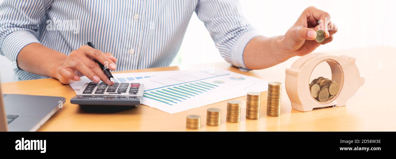 woman hand putting money coin into piggy bank with step of growing ...