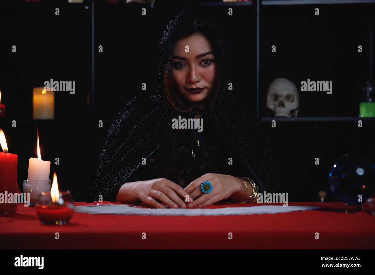 Portrait of beautiful Asian fortune teller in black hood Stock Photo ...