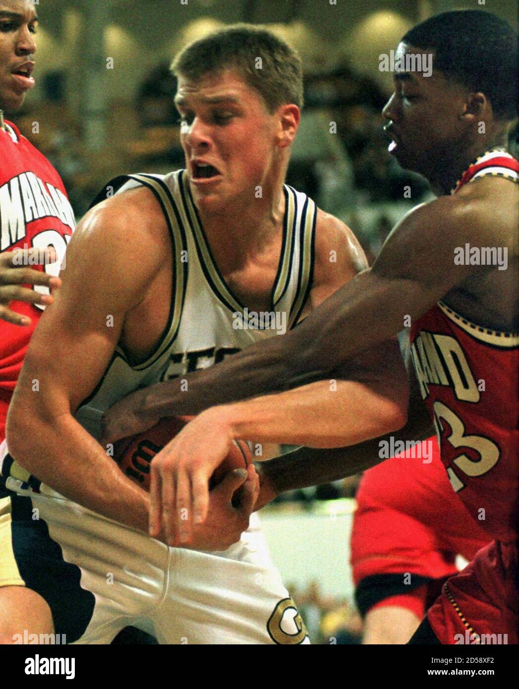 Georgia Tech's Jason Collier (C) and Maryland's Steve Francis (R) fight for  possession of the ball in first half action in Atlanta on February 21.  Maryland's Lonny Baxter (L) helps out on