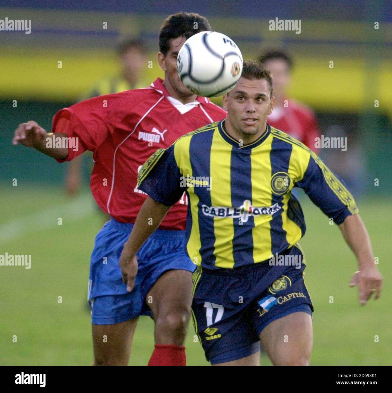 Federico Arias, of the Argentine soccer club Rosario Central, goes for the  ball followed by Paraguayan