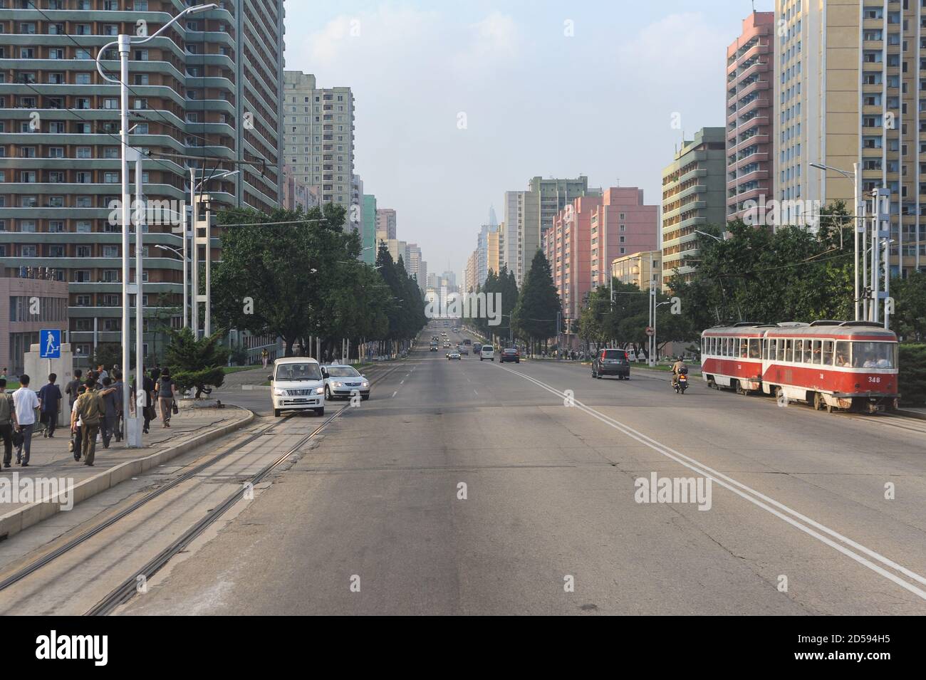 10.08.2012, Pyongyang, North Korea, Asia - An everyday street scene depicts a wide main road with traffic and residential high-rise buildings. Stock Photo
