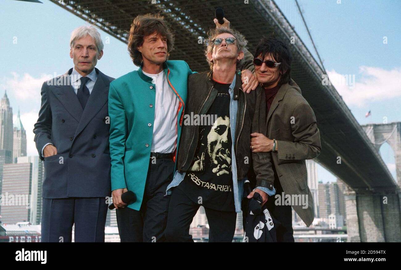 The Rolling Stones rock and roll band pose for photographers under the  Brooklyn Bridge in New York after a press conference where they announced  plans for their upcoming "Bridges to Babylon" world