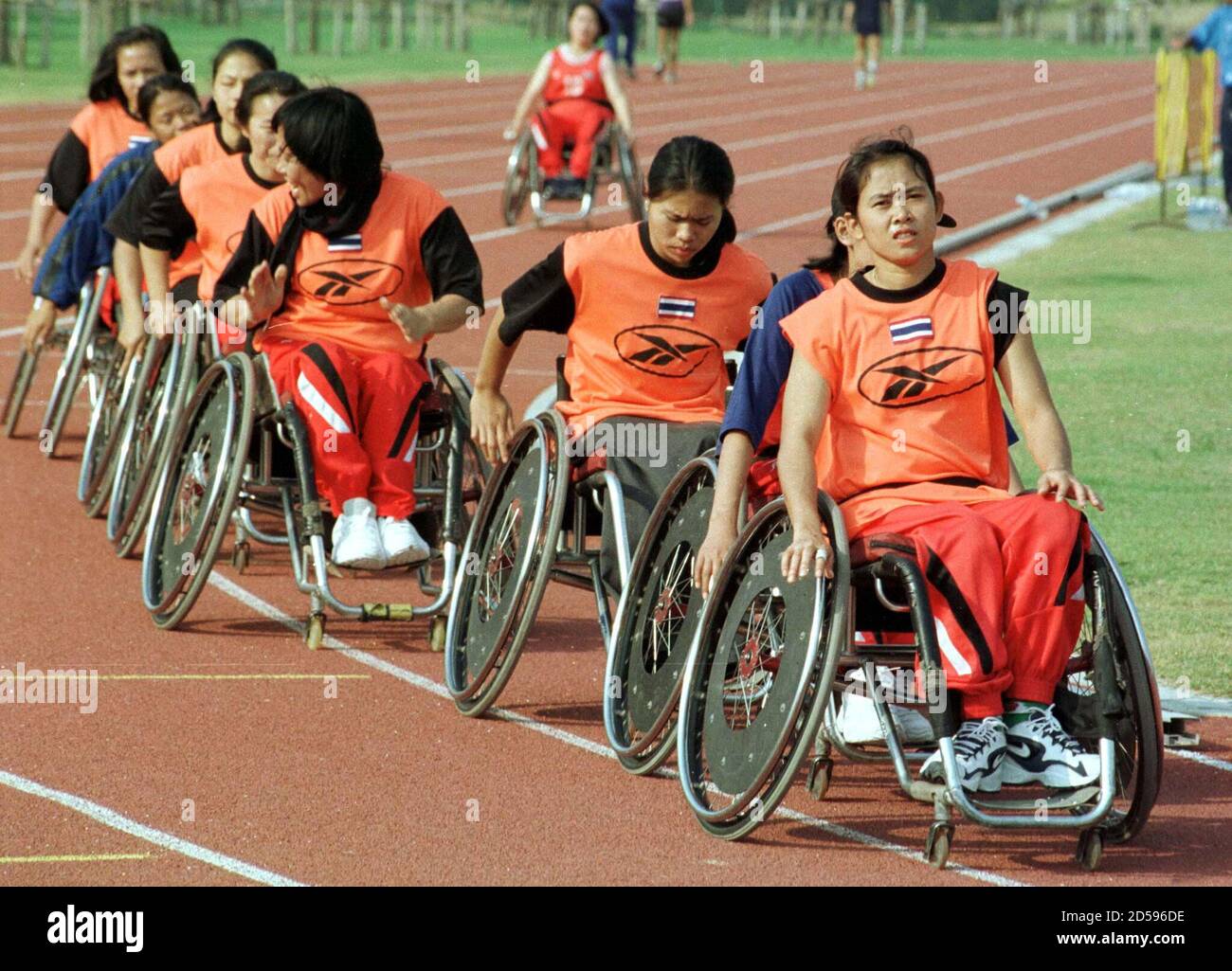 Thai women basketball team members train in wheelchairs at Thammasat  University stadium in Bangkok January 9. About 2,500 athletes and officials  from 34 countries will participate in 15 sporting events in next